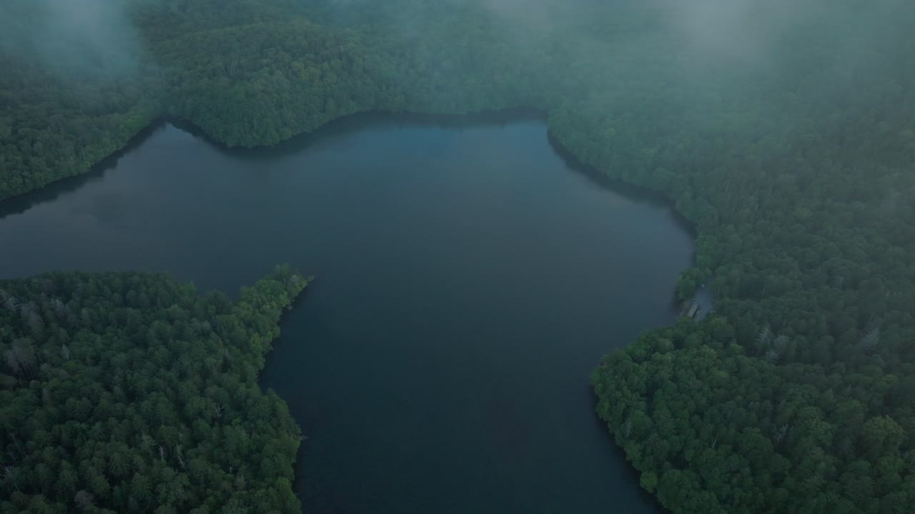 Aerial drone tops down Onneto Lake in Hokkaido Japan, national park landscape around forested area