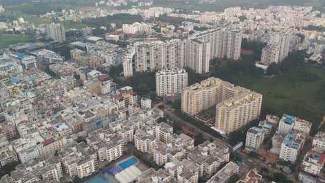 On-a-foggy-morning,-an-aerial-view-of-a-busy-residential-neighbourhood-was-captured-in-Bengaluru,-Karnataka's-Electronic-City,-which-is-encircled-by-apartment-buildings