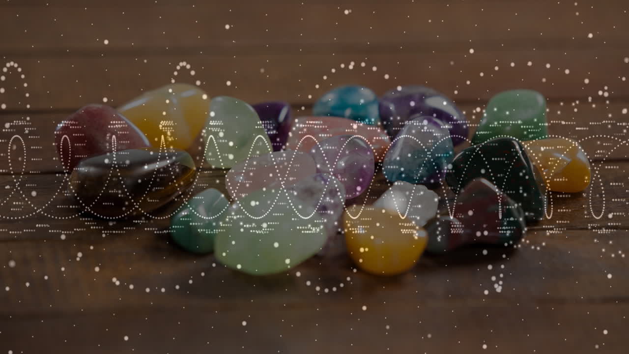 Polished multicolored gemstones sliding on wooden table, showing semi transparent data waveforms
