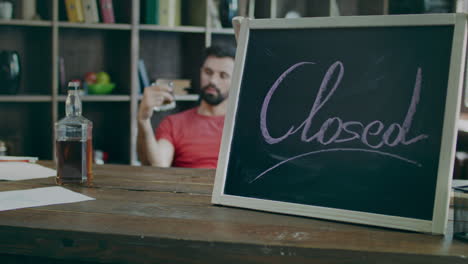 Sign-closed-and-drinking-businessman-with-whiskey-in-glass