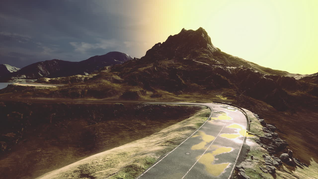 Majestic mountain landscape with a winding road at sunset glow