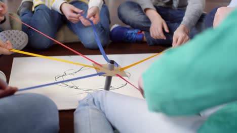 group of kids drawing with one marker in joint effort