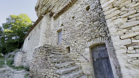 old house made of rough stones with stairs and old door in france historic old farm