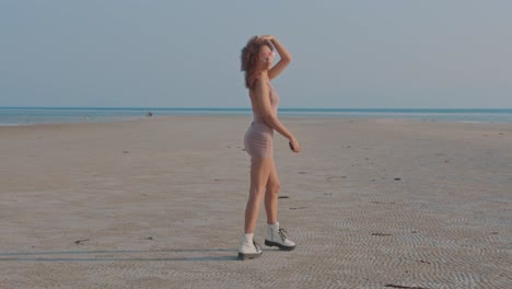 woman in a dress walking on a beach
