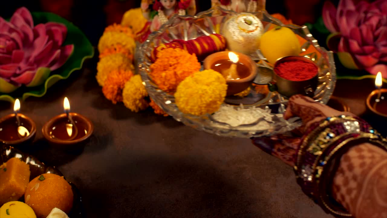 Indian woman performing puja of goddess Lakshmi and Lord Ganesh on Diwali Festival