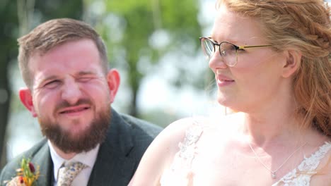 bride and groom sharing a joyful moment outdoors on a sunny day