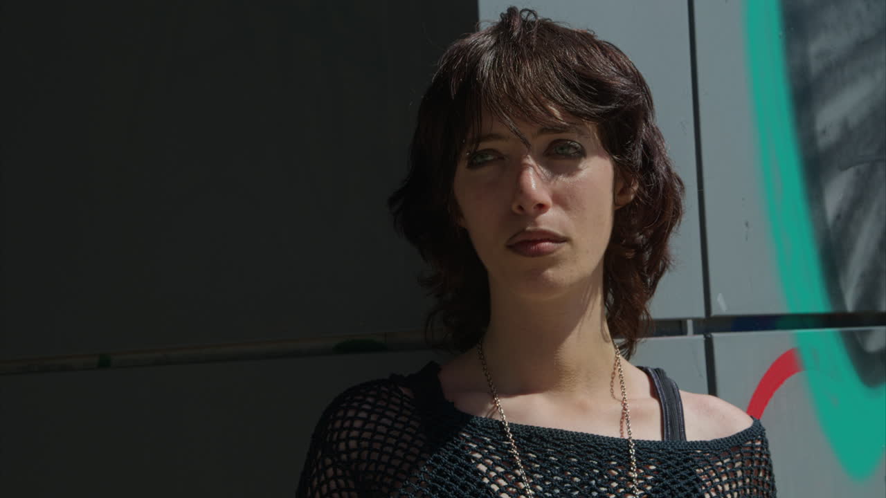 Close Up Fashion Portrait Of Young Alternative Style Woman Woman Standing In Front Of Graffitti On London City Street UK In Real Time