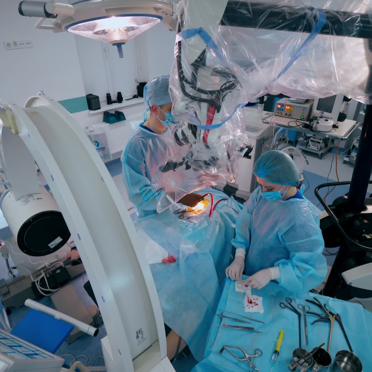 Specialists perform a surgery in hospital. Modern medical equipment surgeons use during operation. New technology in medicine. Top view.