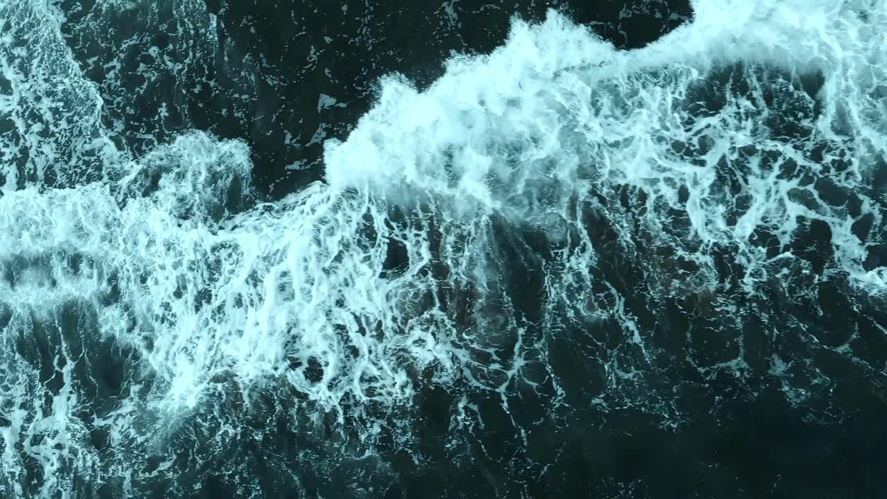 AERIAL: Overhead aerial shoot of the waves on the sea