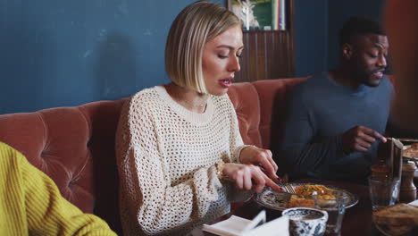 group of people eating in restaurant of busy traditional english pub