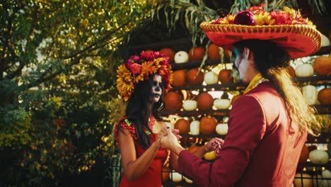 couple dancing in day of the dead costumes