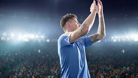 happy soccer player on a football stadium