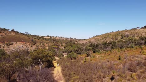 perth hills at bells rapids hiking area aerial rise up over trail near dry swan river
