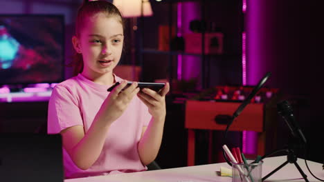 joyous child influencer showcasing her most used apps on her smartphone