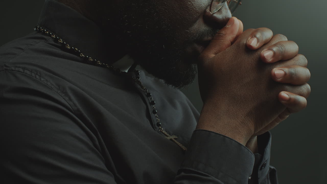 Close-Up of Catholic Priest Whispering Prayer