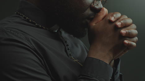 close-up of catholic priest whispering prayer