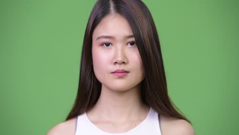 young beautiful asian businesswoman covering ears as three wise monkeys concept