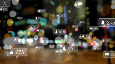 animation of social media icons against blurred view of night city traffic