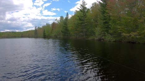 POV-while-fisherman-who-is-off-camera-casts-a-lure-into-the-lake