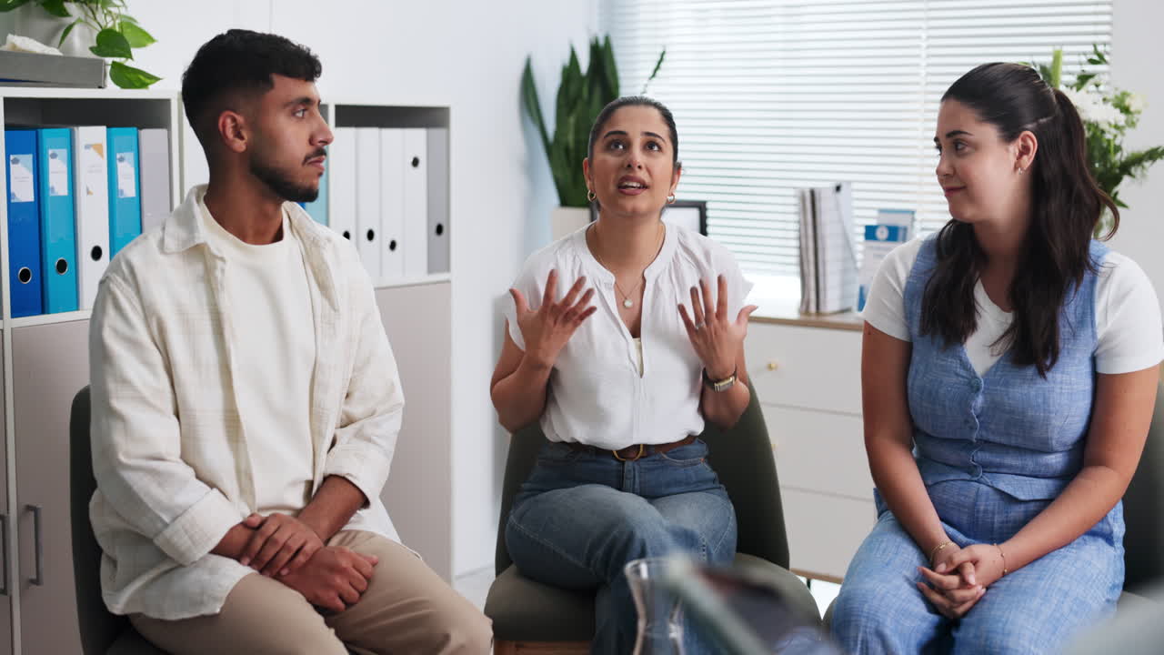 Young Woman Speaking in a Group Discussion in an Office