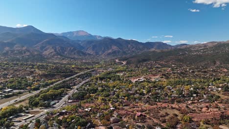 panoramic aerial dolly above highway and community of colorado springs near garden of the gods