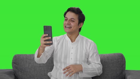 Happy-Indian-man-talking-on-video-call-Green-screen