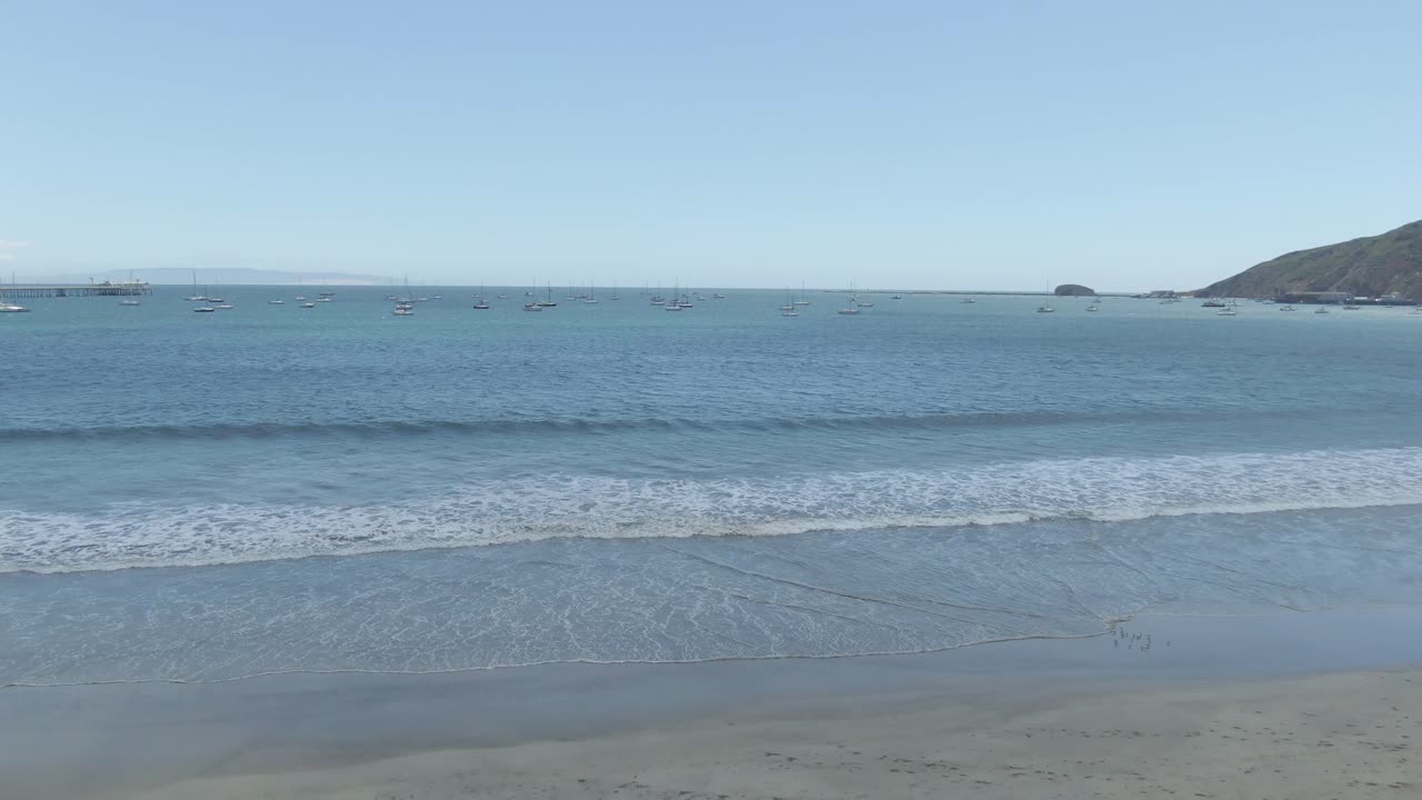 High-altitude drone footage capturing the scenic beauty of Avila Beach on California’s Central Coast. This cinematic clip features the sparkling Pacific Ocean, sandy shoreline, and coastal landscape u