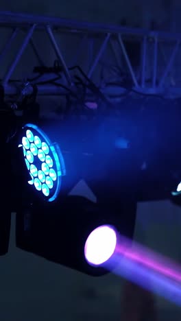 spotlights illuminate the stage at a concert