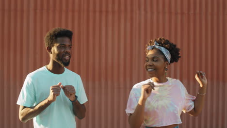 Cheerful-African-American--Man-and-Woman-Dancing-Outdoors