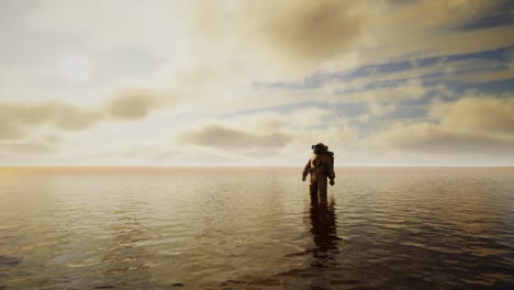 spaceman in the sea under clouds at sunset