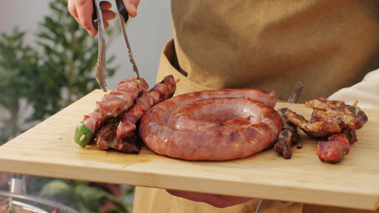 Traditional spanish barbeque, big sausage chorizo botifarra, pork and beef ribs on grill with fire, american style cooking, chef grilling meat fat food, steaks and sausages on bbq. High quality 4k footage
