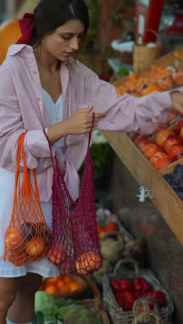 woman shopping for fruit at a farmers market