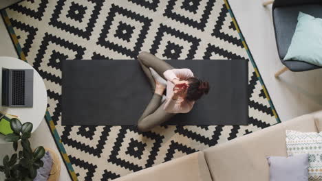 woman practicing yoga at home