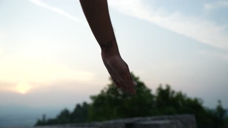 Close-up-shot-of-hand-touching-the-ground-next-to-feet-in-hatha-yoga-pose-in-the-morning-at-dawn