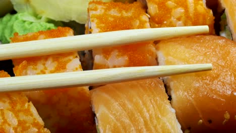 japanese sushi rolls with chopsticks rotates