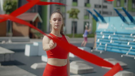 woman performing ribbon dance in an urban setting