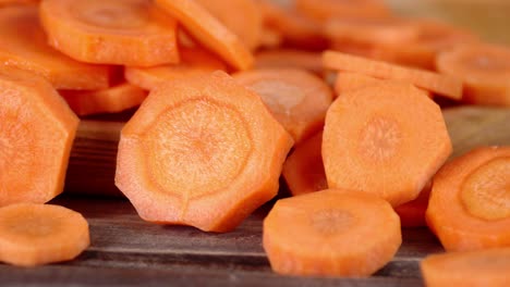 the slices of fresh orange carrots on the table.