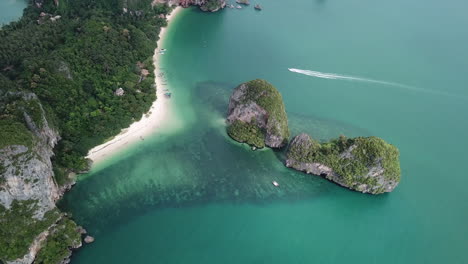 exotic travel destination, seacliffs in tropical sea and white sand beach, birds eye aerial view of railay beach, krabi, thailand