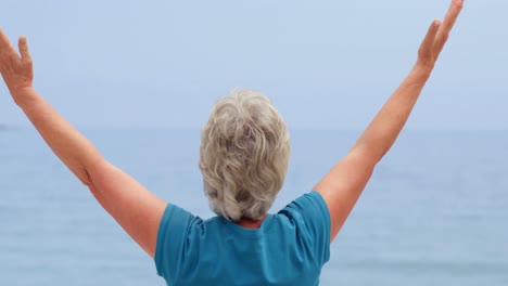 woman facing the sun with open arms