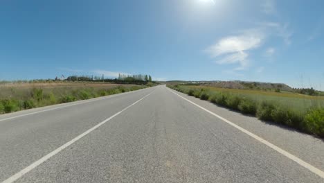 pov motorcycle ride along clear roads with cloudless blue skies on a sunny day