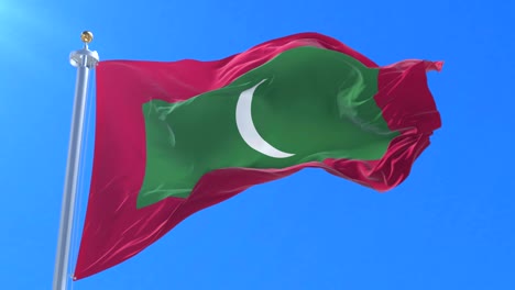 flag of the maldives waving at wind with blue sky in slow, loop