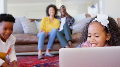 Front-view-of-cute-black-kids-having-fun-in-living-room-at-comfortable-home-4k