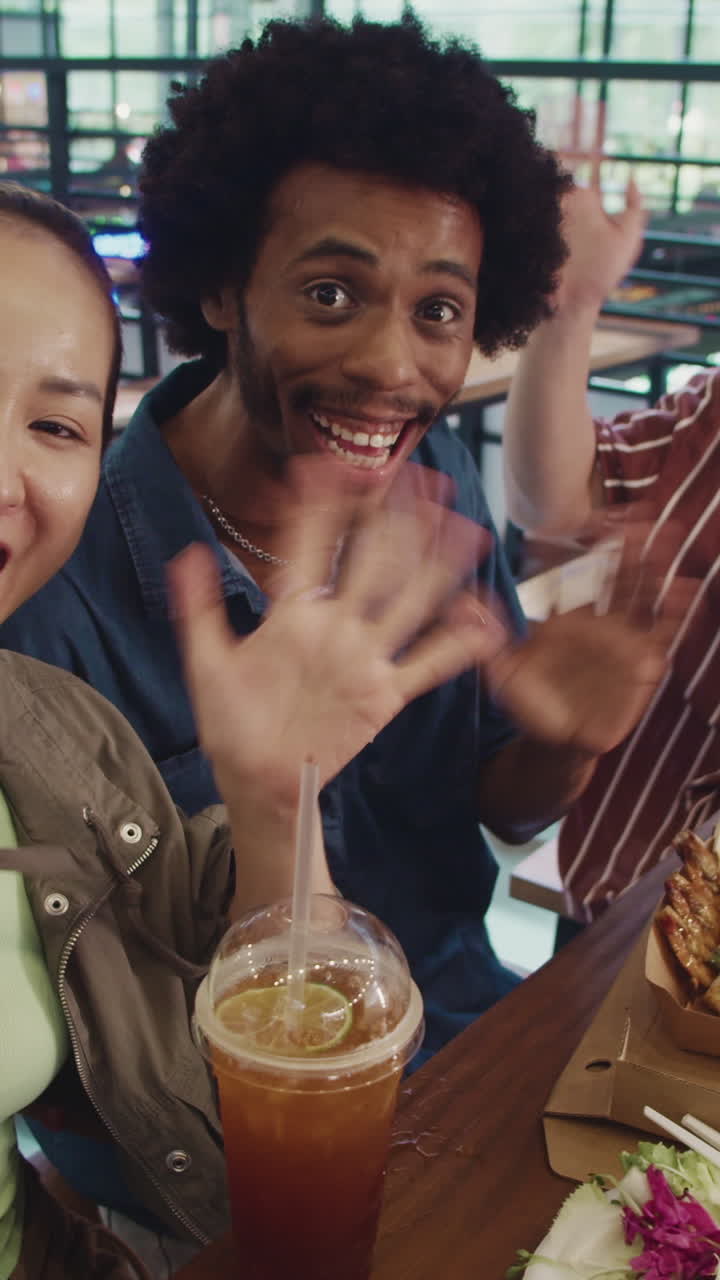Vertical POV of Friends Vlogging about Street Food at Local Food Market