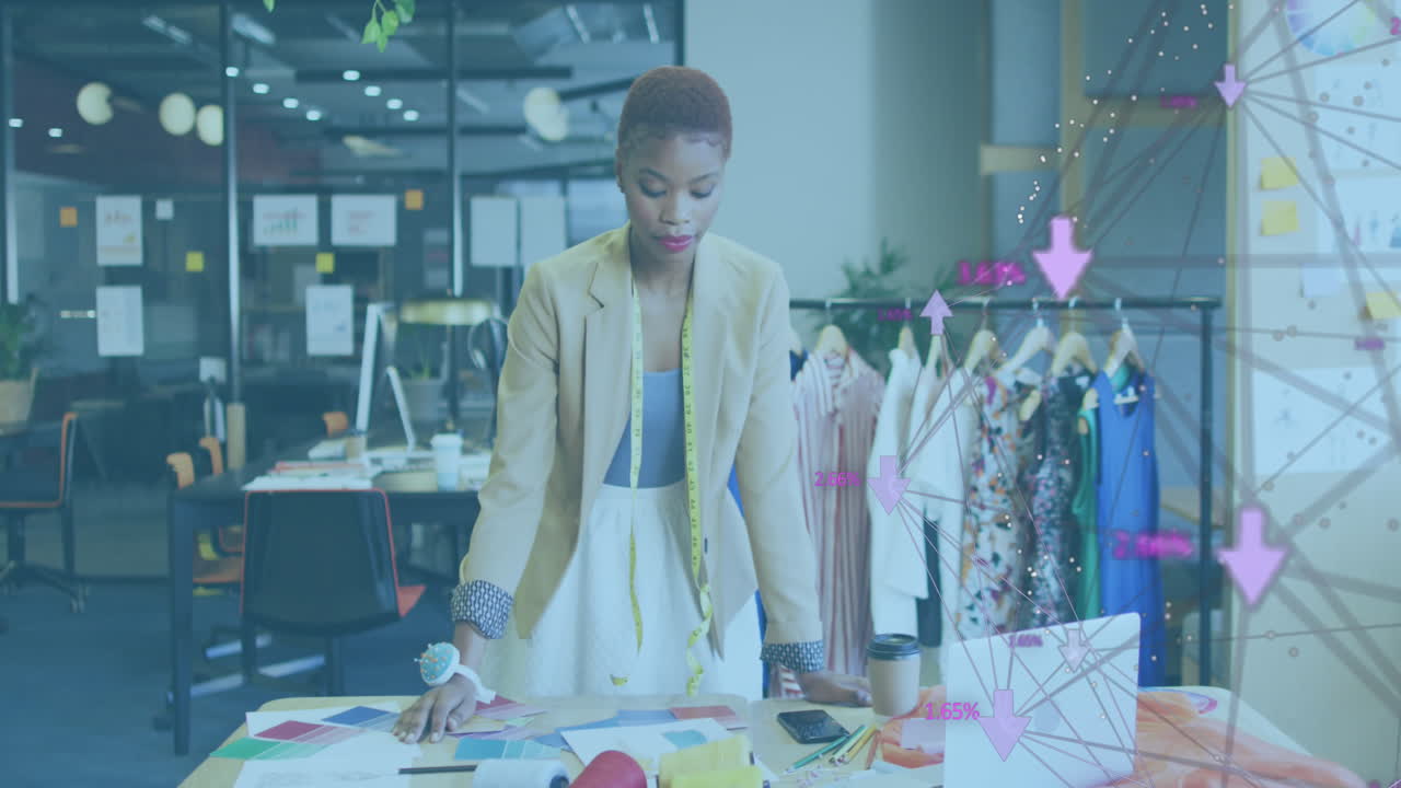 Animation of network of connections with icons over african american businesswoman at office