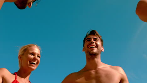 Friends-breaking-from-a-huddle-on-the-beach