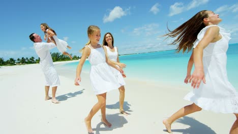 caucasian parents and daughters on island beach vacation