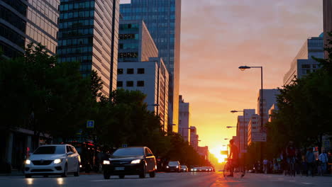 cyclists and traffic on an urban street at sunset