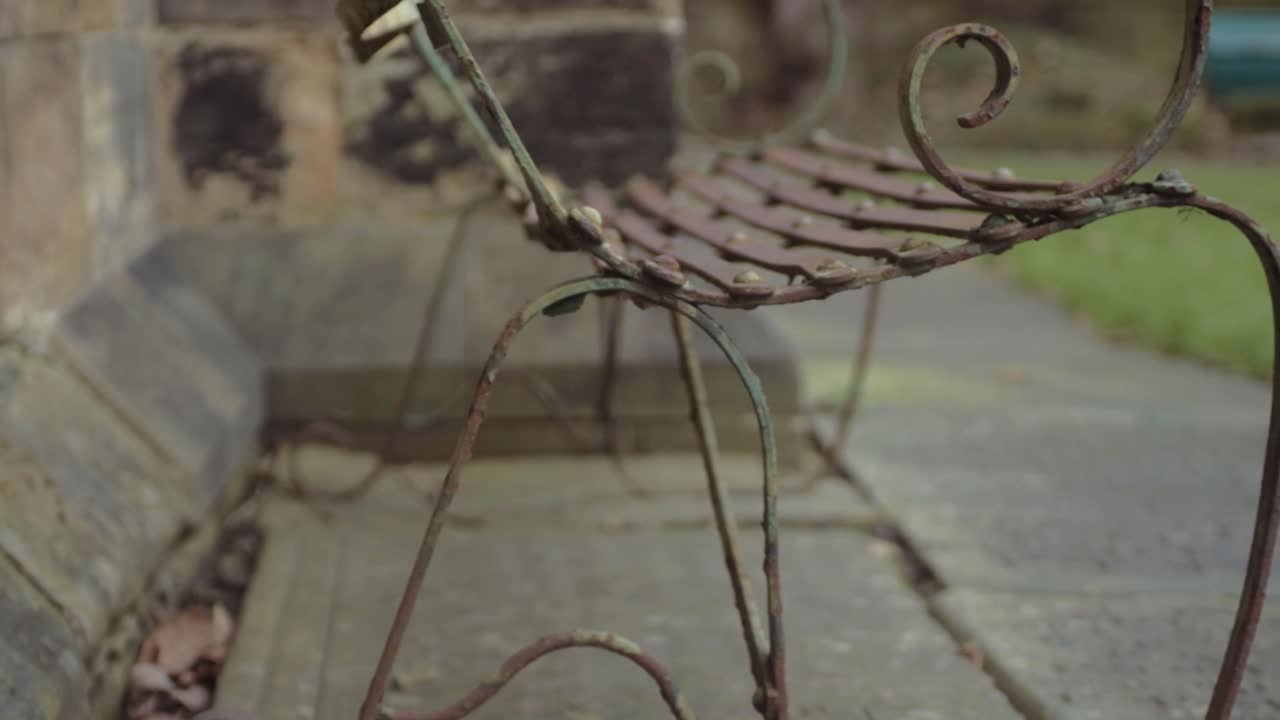 Rusty old metal bench in churchyard