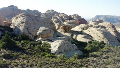 arid desert landscape with massive rock formations and sparse shrubs