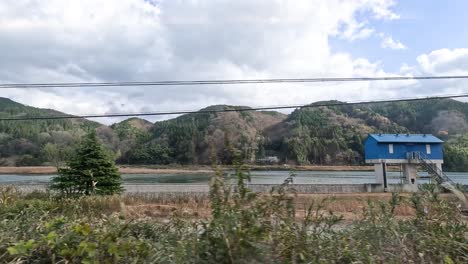 passing by a tranquil lake and mountainside landscape